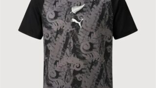 Gray and black football jersey with raglan sleeves and abstract pattern, white Puma logo on the chest.